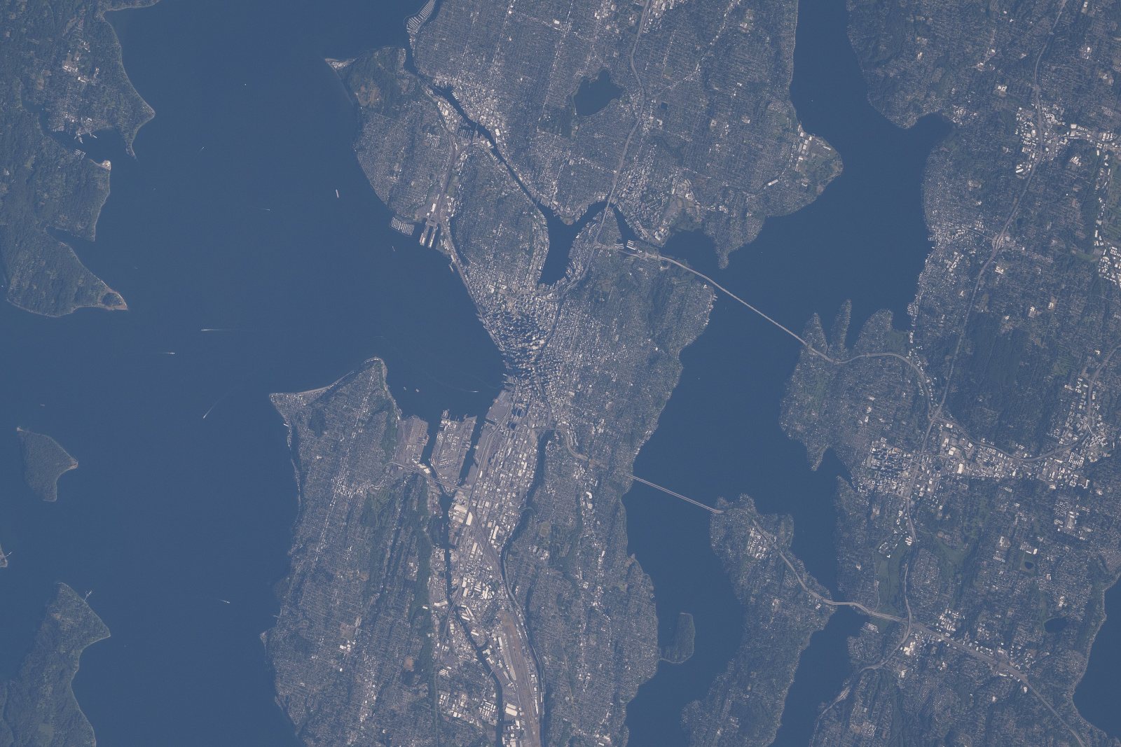 Satellite view of Seattle between Puget Sound and Lake Washington, with the I-90 and SR 520 bridges