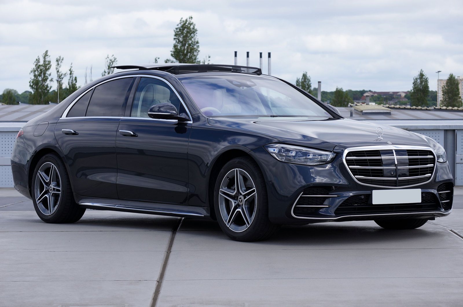 Dark Mercedes-Benz S-Class sedan parked on a rooftop deck